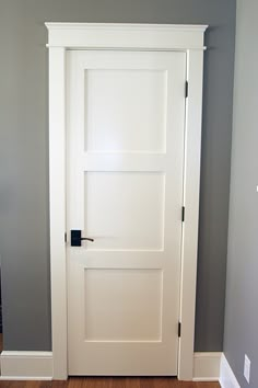 a white door in the corner of a room