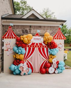 a circus themed birthday party with balloon decorations and balloons on the front of a building