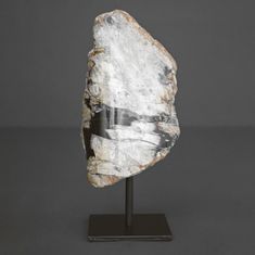 a piece of rock sitting on top of a metal stand