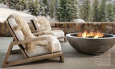 an outdoor fire pit with two chairs around it