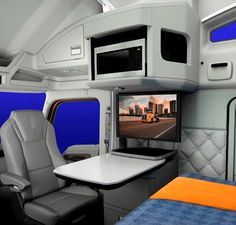 the interior of an airplane with a bed and desk in it, as well as a flat screen tv