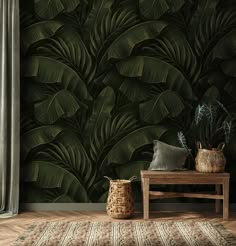 a living room with a large green leaf wallpaper and wooden bench in front of it