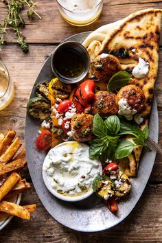 a plate full of grilled vegetables and pita bread