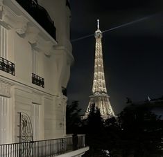 the eiffel tower is lit up at night