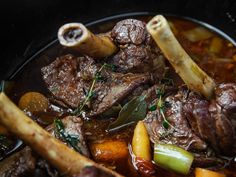 a pot filled with meat and vegetables on top of a stove