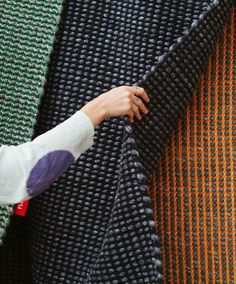 a woman is holding onto a piece of fabric