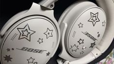 two white headphones with stars on them