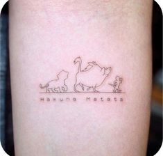 a small tattoo on the arm of a woman with three cats and one dog in it