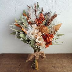 a vase filled with lots of different types of flowers