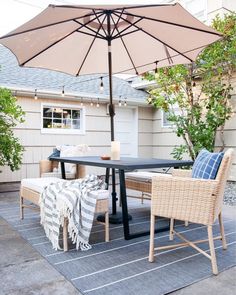 an outdoor table and chairs with an umbrella