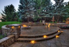 an outdoor patio with stone steps and fire pit