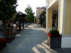 an empty street with shops on both sides