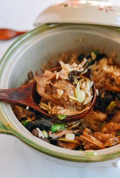 a wooden spoon full of food in a pot