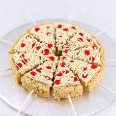 a cake with white frosting and red sprinkles