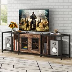 an entertainment center in a living room with a large television on the wall and speakers