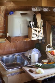 an image of a kitchen counter with cooking utensils on it and a jug of water in the background