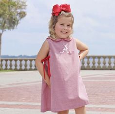 Roll Tide! Your little one will look adorable this football season in our Alabama Embroidered Red Gingham Dress. This A-line collared dress featuring Alabama embroidered logo and side-tie red bows. Add a name monogram! Your little one will be the talk of the tailgate in their NCAA licensed collegiate gear from Smocked Auctions. Alabama | gameday | football | kids clothes | football kids outfits | gameday outfits for kids | smocked outfits | kid’s closet inspo | kids style | kids trends | kids Gameday Outfits, Collared Dress, Football Kids, Kids Trend, Red Gingham, Gameday Outfit, Roll Tide, The Talk