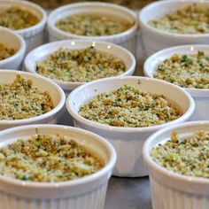 several white bowls filled with food on top of a table