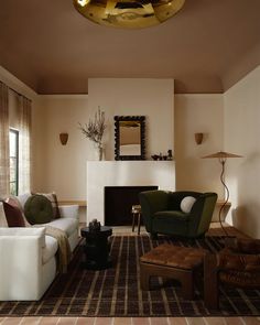 a living room filled with furniture and a fire place in the middle of the room