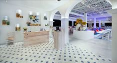 the interior of a restaurant with white walls and black and white checkered flooring