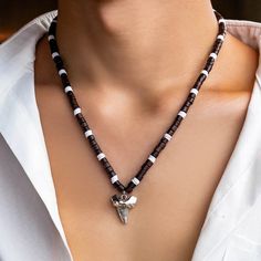 Elevate your surfer style with this Shark Tooth Surfer Necklace for Men! This tribal-inspired necklace features wooden beads and a genuine bone shark tooth charm, perfect for any bohemian-themed outfit. The adjustable length makes it a great fit for anyone. 🌊🦈 #SurferStyle #TribalNecklace #SharkToothCharm #BohemianFashion #MensJewelry #MLDTrading #Necklace #Jewelry #eBay Shark Teeth Necklace, Collier Heishi, Sea Wolves, Clay Chain, Teeth Necklace, Black Chain Necklace, Surf Necklace, Shark Tooth Pendant, Tooth Charm