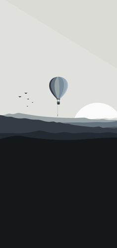 a hot air balloon flying in the sky over an ocean with birds on it's side