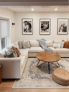 a living room filled with furniture and pictures on the wall