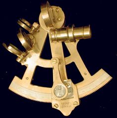 a gold clock with two gears attached to it