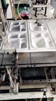 a machine that has some trays in it's place to be filled with liquid