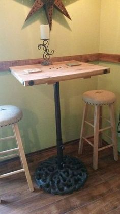 a table with stools and a star on the wall above it in a corner