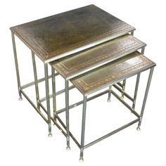 three metal nesting tables sitting on top of each other