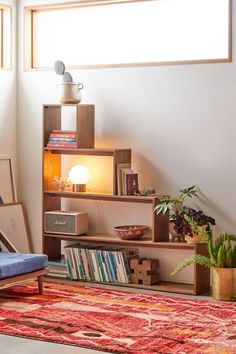 a living room filled with lots of furniture and bookshelves next to a window