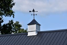 a weather vane on top of a metal roof