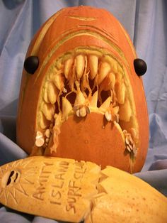 a carved pumpkin with its mouth open and the word happy halloween on it's side