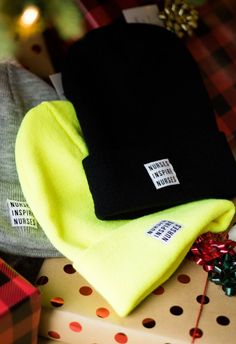 three beanies sitting on top of a pile of presents