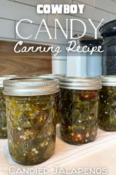 three jars filled with pickles sitting on top of a counter