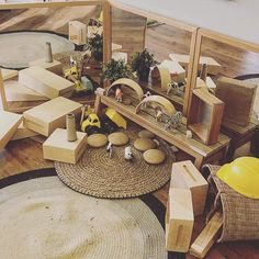 a room filled with lots of wooden furniture and toys on top of a hard wood floor