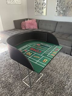 a living room with a couch and a table in the middle that has a roulejack game on it