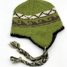 a green knitted hat with braids on the brim and two other hats attached to it