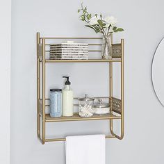 a bathroom shelf with soap, toothbrushes and other items on it next to a mirror