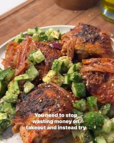 a white plate topped with meat and veggies on top of a wooden table