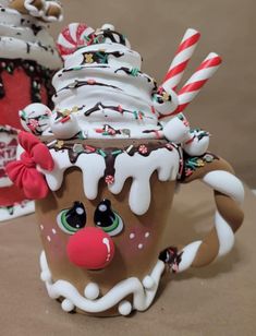 a close up of a cup cake with frosting and candy canes on it