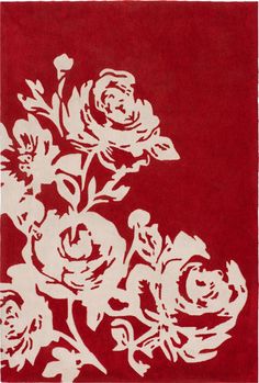 a red rug with white flowers on it