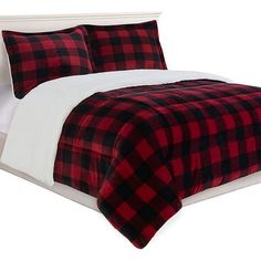 a red and black plaid comforter set on a bed