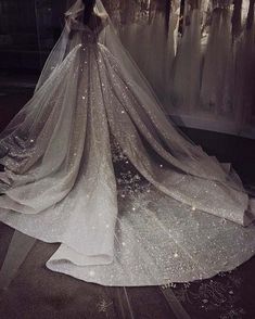 the back of a wedding dress with sparkling sequins on it's skirt