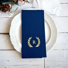 a blue passport sitting on top of a white plate next to a bouquet of flowers