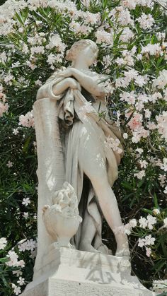 a statue is shown in front of some flowers