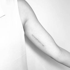 a person with a tattoo on their arm that reads, i am not sure if it is