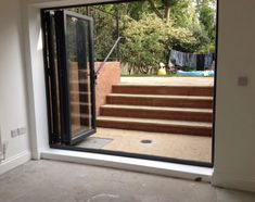 an open door leading to a patio with steps