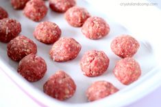 raw meatballs in a white tray ready to be cooked